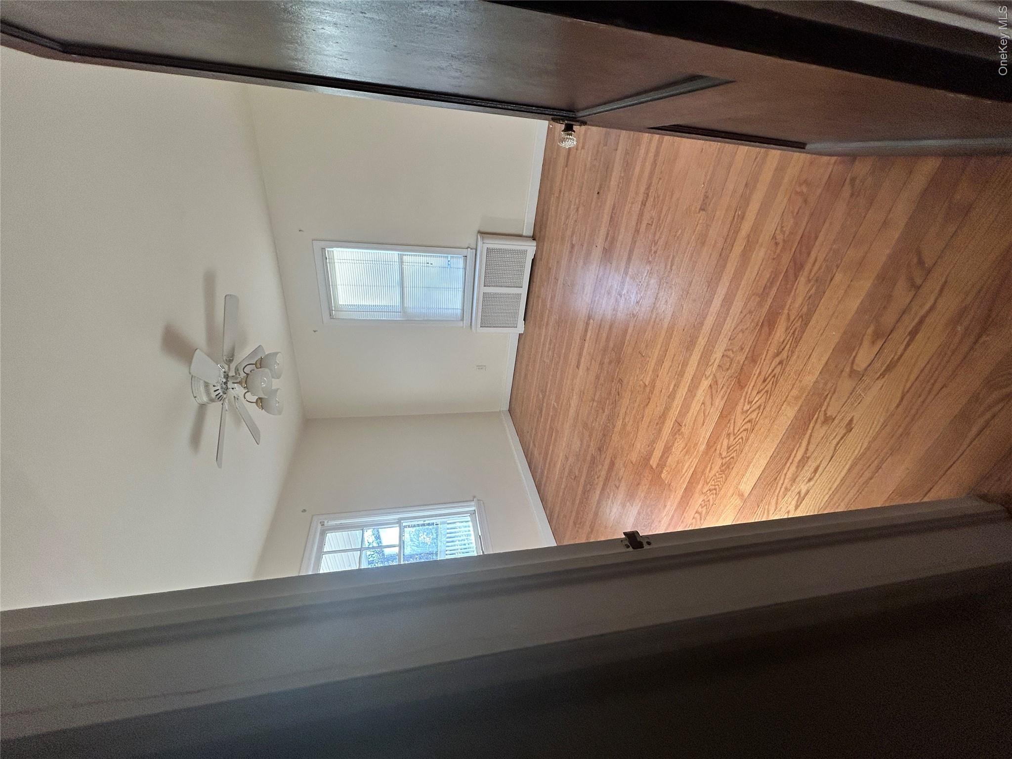 853 Little Britain Road New Windsor, NY 12553 - Photo 4 of 22 wooden floor in an empty room with a window