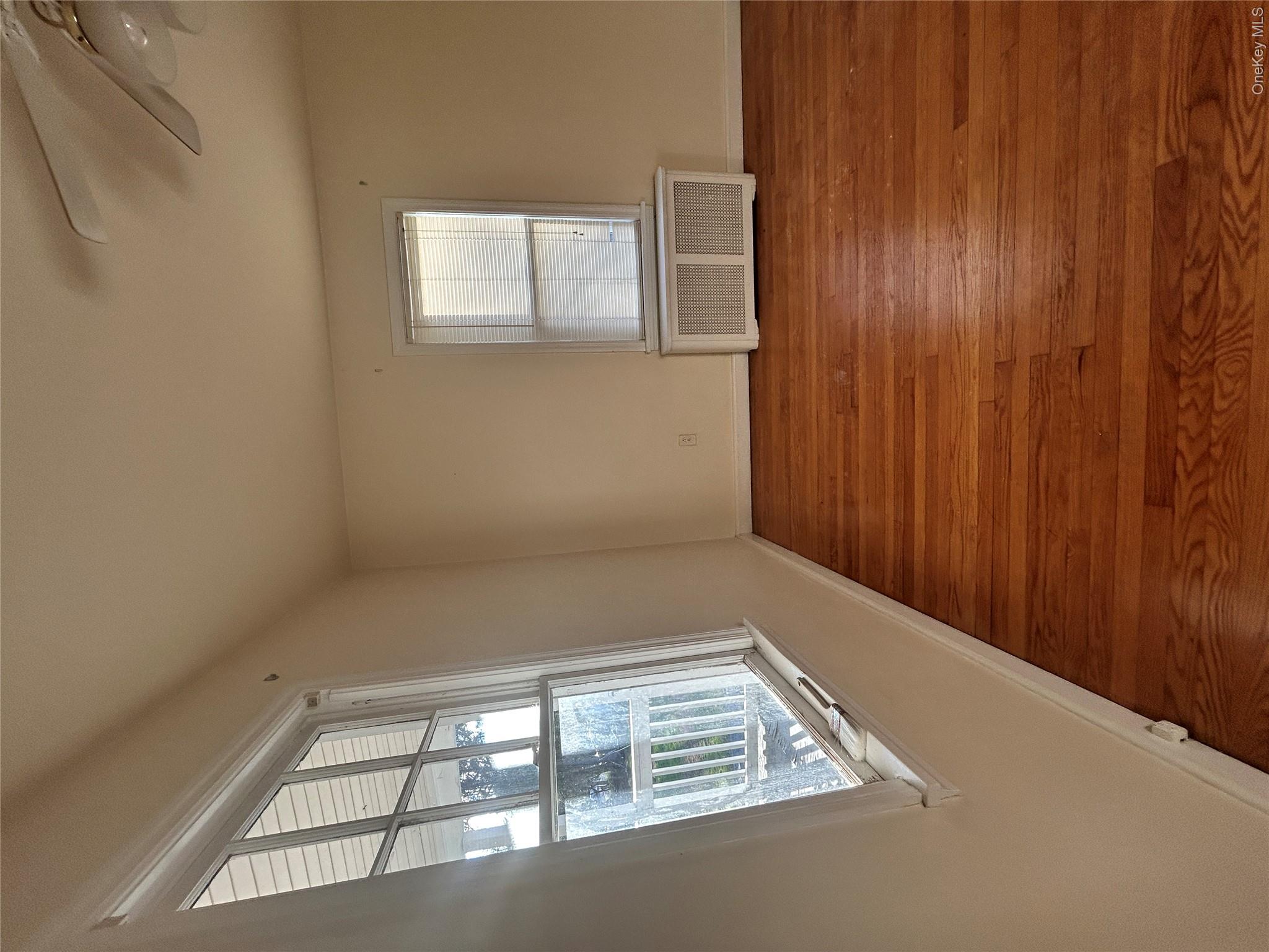 853 Little Britain Road New Windsor, NY 12553 - Photo 6 of 22 a view of an empty room with wooden floor and a window