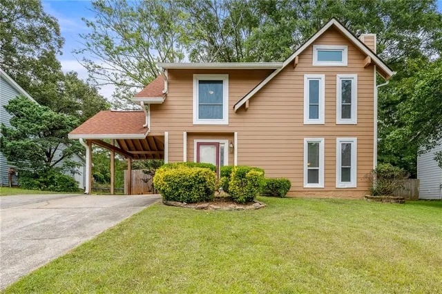 a front view of a house with garden