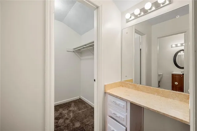 a bathroom with a granite countertop sink a mirror and a vanity