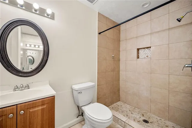 a bathroom with a sink a toilet and a mirror