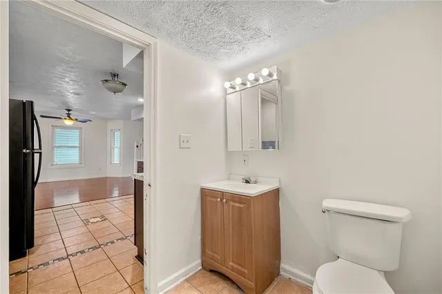 a bathroom with a toilet a sink and mirror