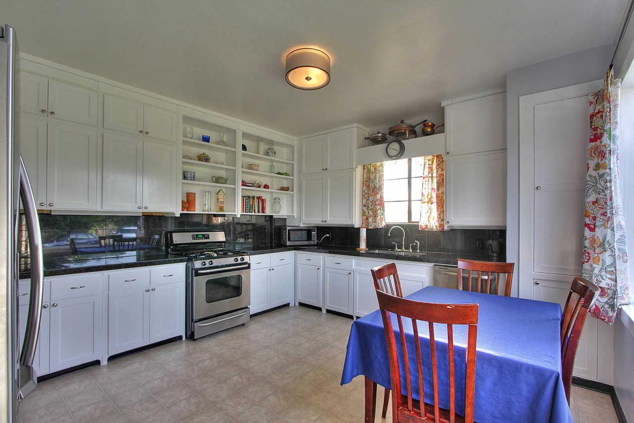 3035 Valdez Road Pebble Beach, CA 93953 - Photo 12 of 60 a kitchen with stainless steel appliances granite countertop a stove a sink dishwasher and cabinets with wooden floor