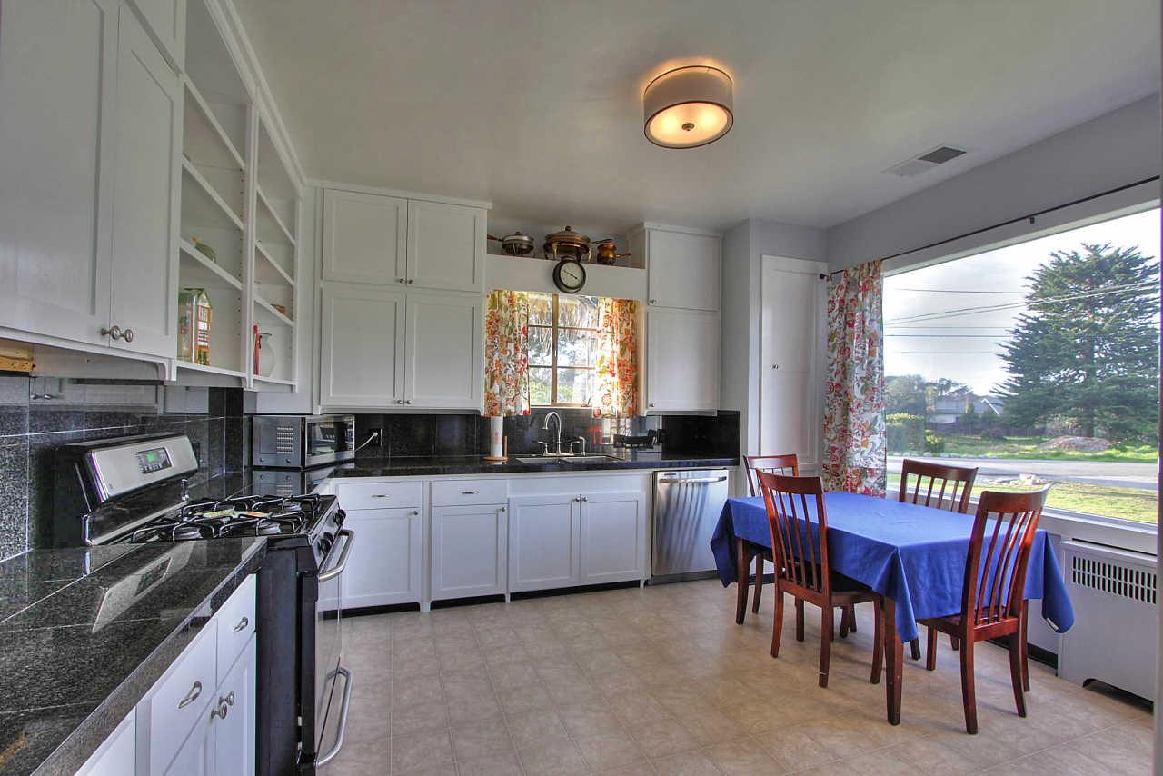 3035 Valdez Road Pebble Beach, CA 93953 - Photo 14 of 60 a kitchen with granite countertop a sink stove and chairs
