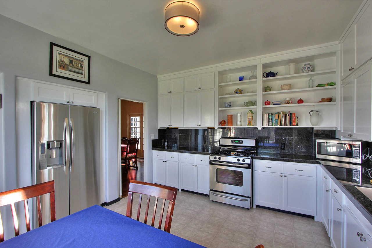 3035 Valdez Road Pebble Beach, CA 93953 - Photo 15 of 60 a kitchen with stainless steel appliances granite countertop a refrigerator and a stove top oven