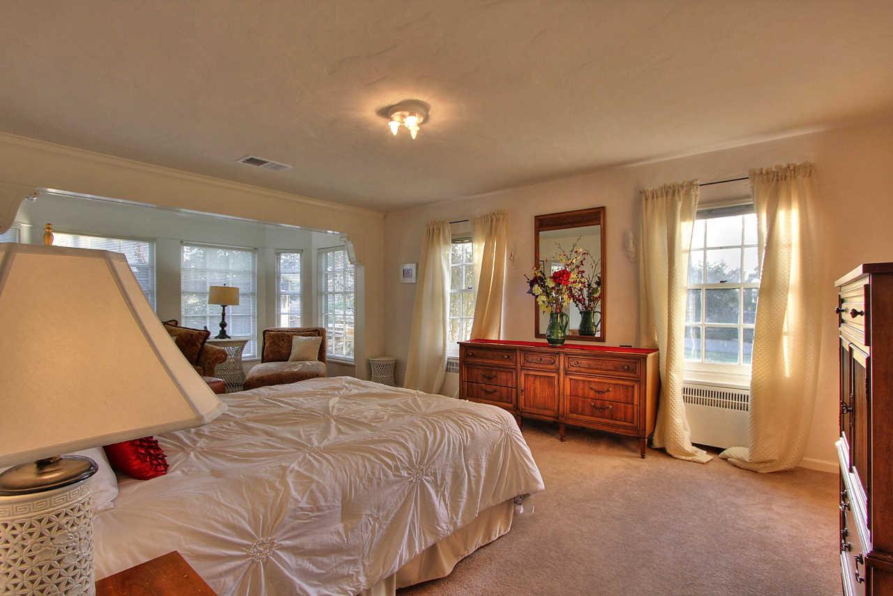 3035 Valdez Road Pebble Beach, CA 93953 - Photo 17 of 60 a bed room with a bed and a large mirror
