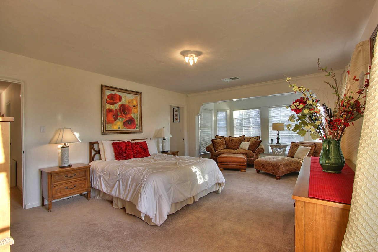 3035 Valdez Road Pebble Beach, CA 93953 - Photo 18 of 60 a bedroom with bed and a couch