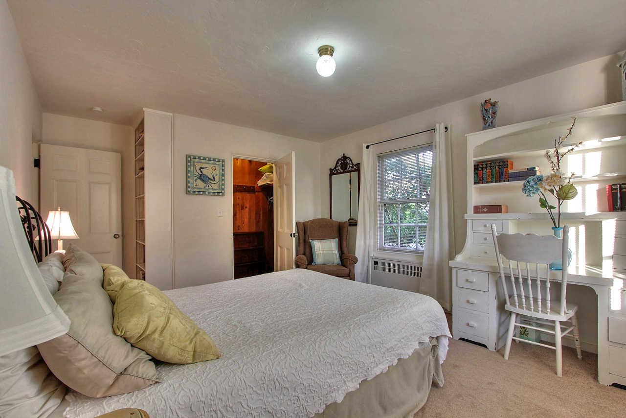 3035 Valdez Road Pebble Beach, CA 93953 - Photo 28 of 60 a bedroom with a bed and a chair