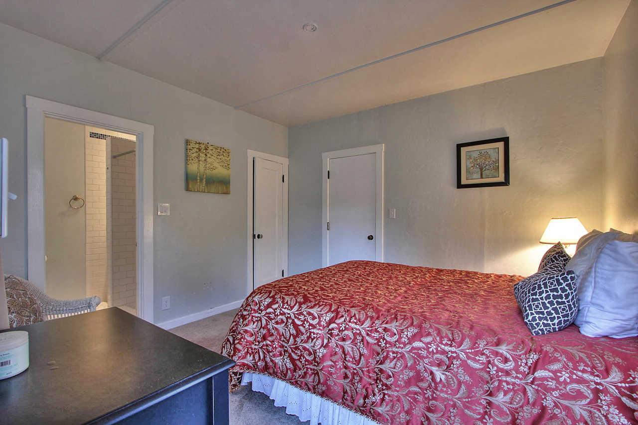 3035 Valdez Road Pebble Beach, CA 93953 - Photo 38 of 60 a bedroom with a bed and a table with potted plant