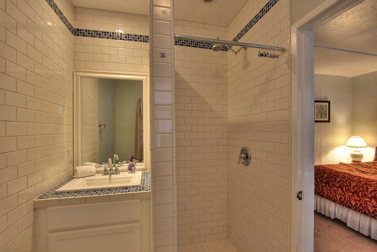 3035 Valdez Road Pebble Beach, CA 93953 - Photo 39 of 60 a bathroom with a granite countertop sink a mirror and shower