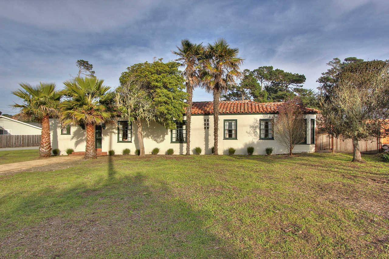 3035 Valdez Road Pebble Beach, CA 93953 - Photo 42 of 60 a front view of a house with a big yard and a large tree