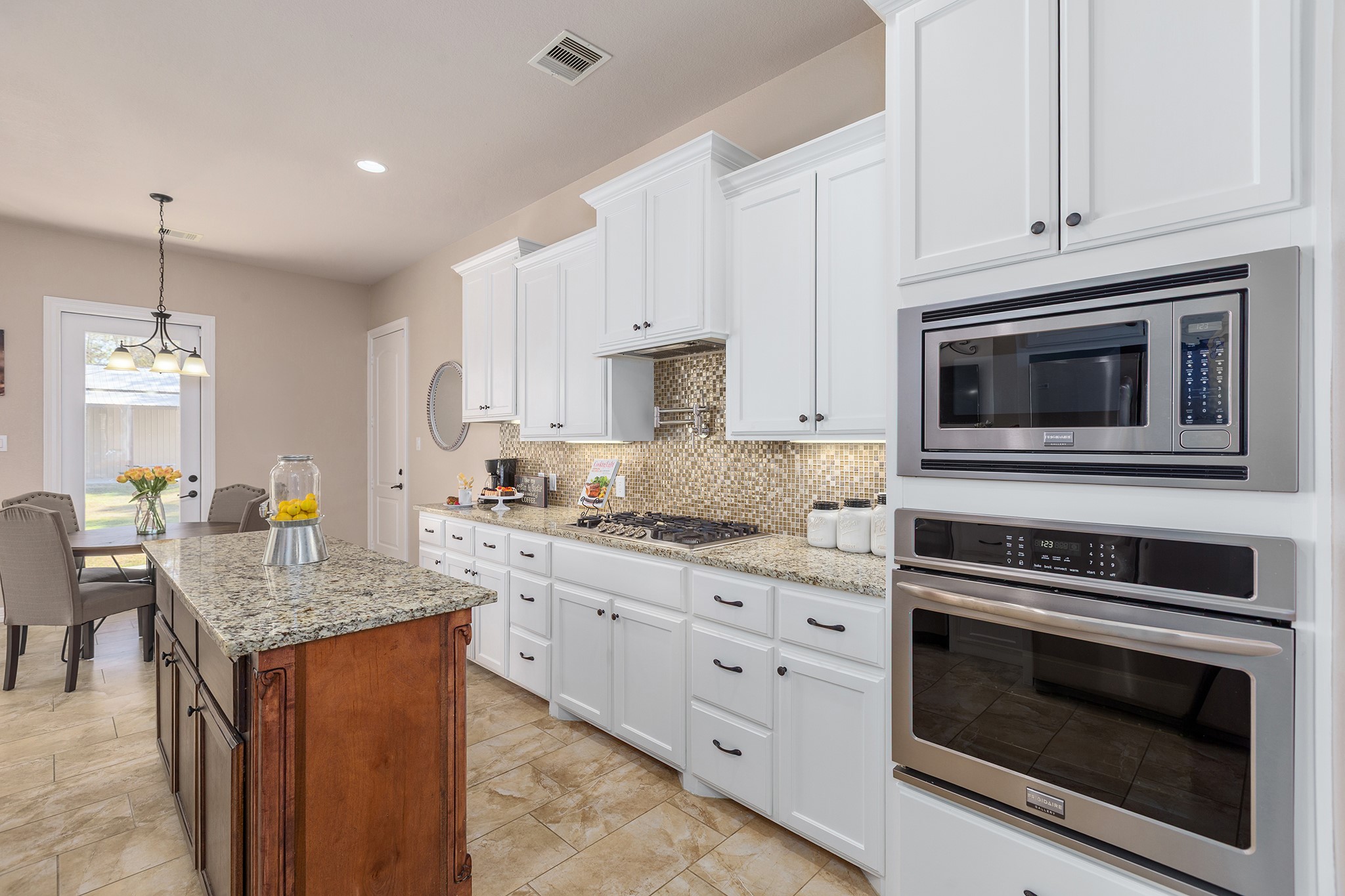 27688 Rio Blanco Drive Splendora, TX 77372 - Photo 20 of 50 a kitchen with granite countertop cabinets stainless steel appliances and wooden floor