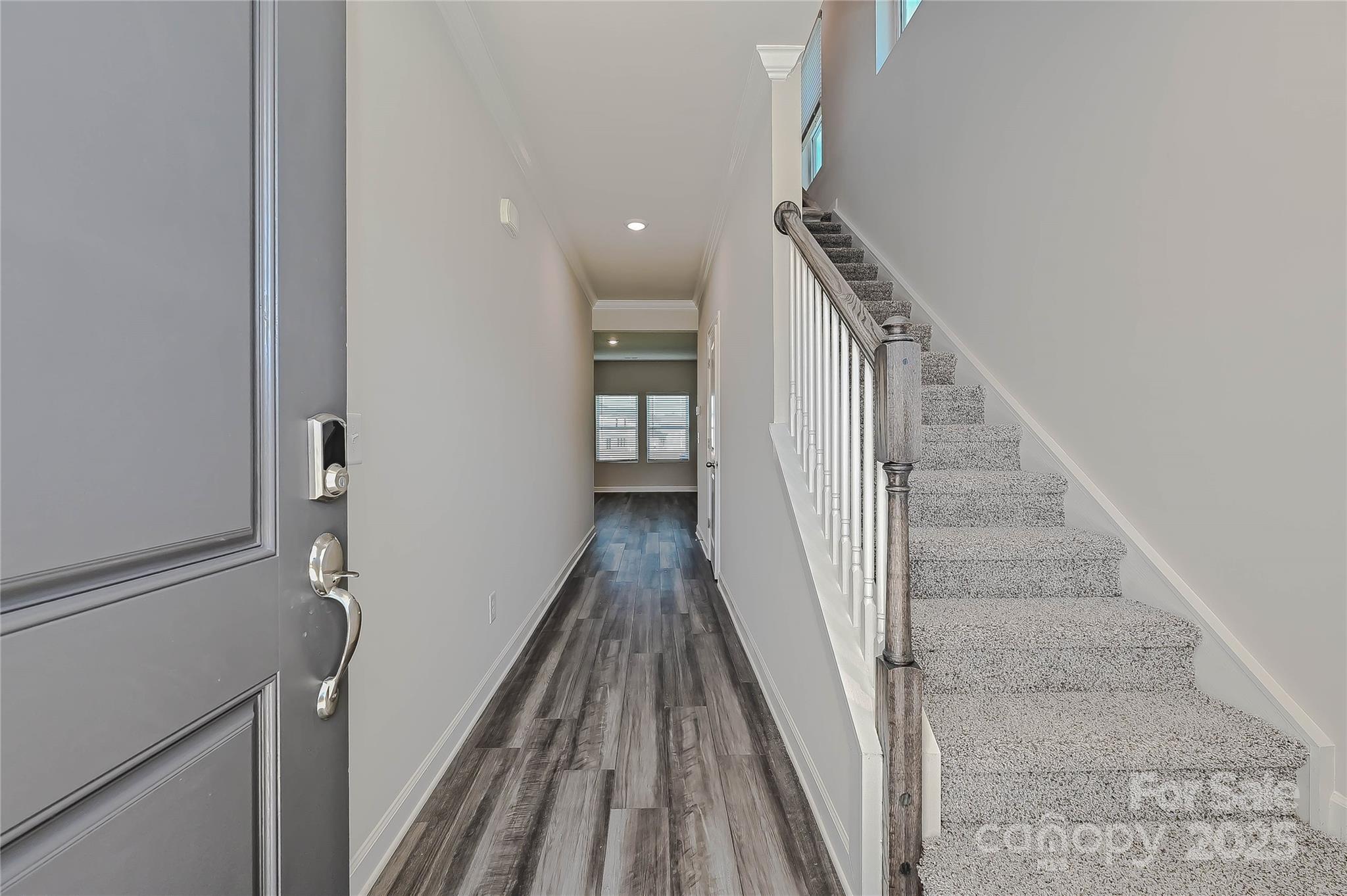 1313 30th St Lane Northeast Conover, NC 28613 - Photo 2 of 27 a view of a hallway with wooden floor and staircase