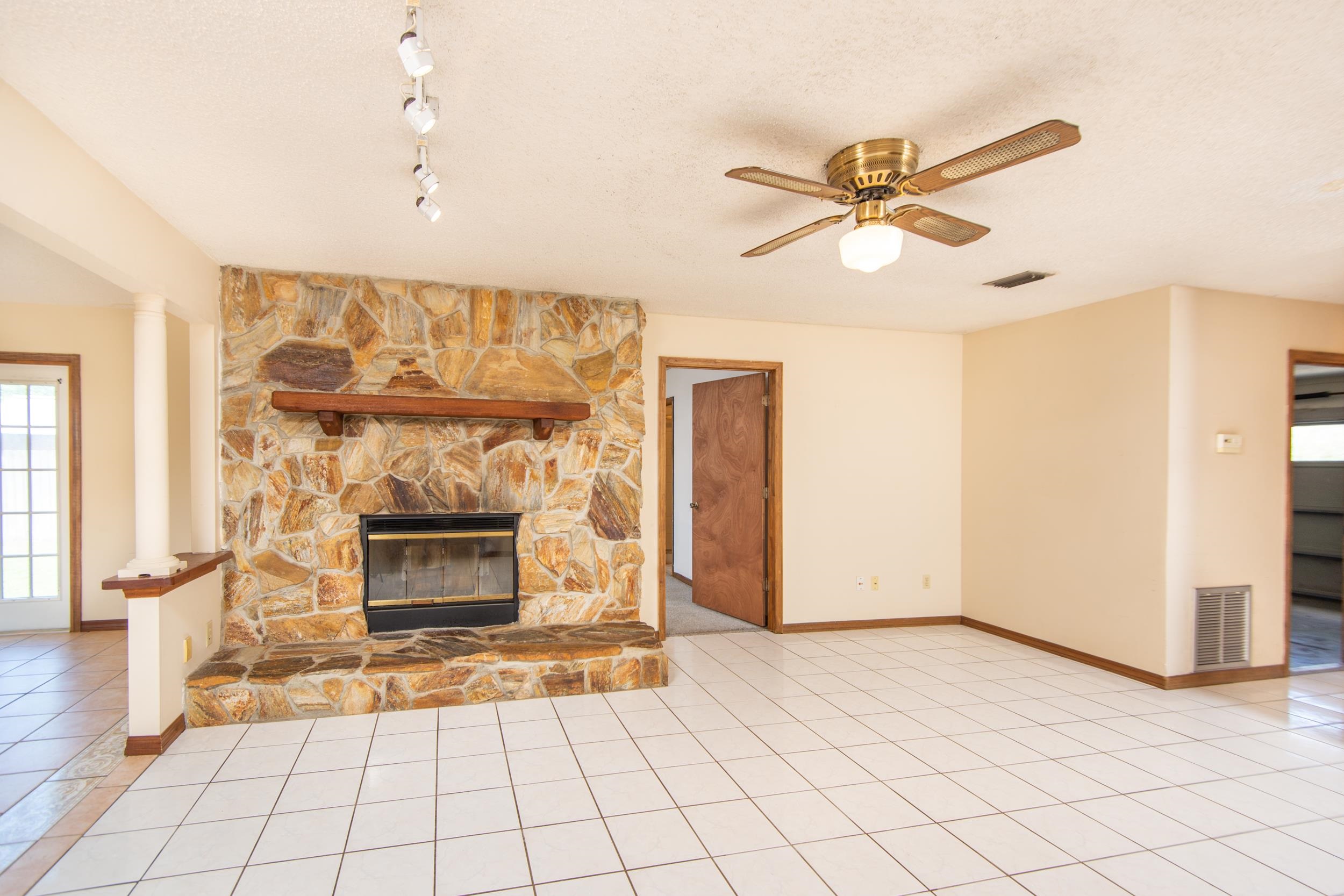 328 Linden Road St. Augustine, FL 32086 - Photo 14 of 62 a view of empty room with fireplace and fan