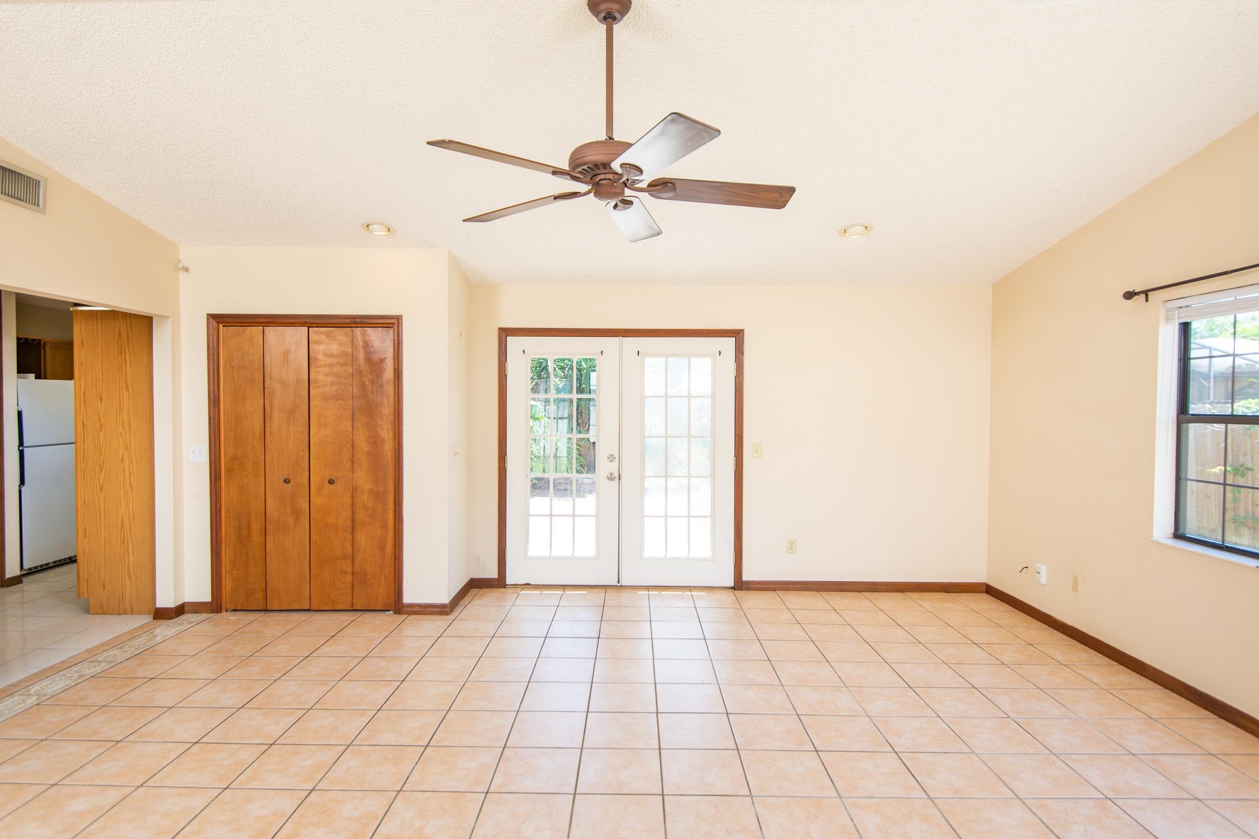 328 Linden Road St. Augustine, FL 32086 - Photo 24 of 62 a view of an empty room with window and chandelier fan