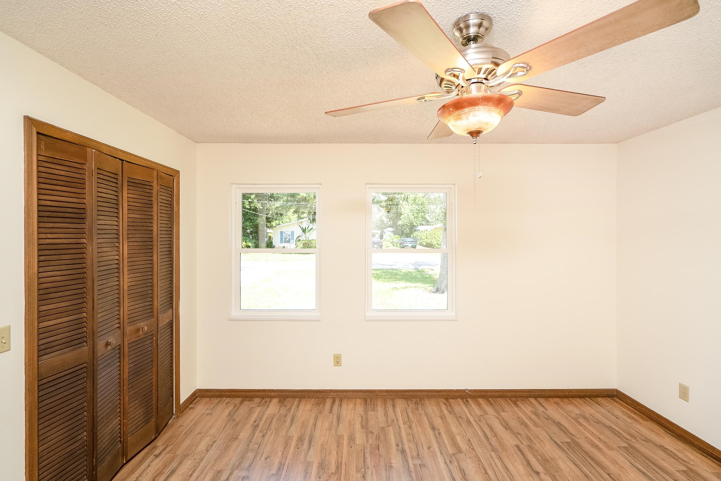 328 Linden Road St. Augustine, FL 32086 - Photo 41 of 62 an empty room with wooden floor and windows