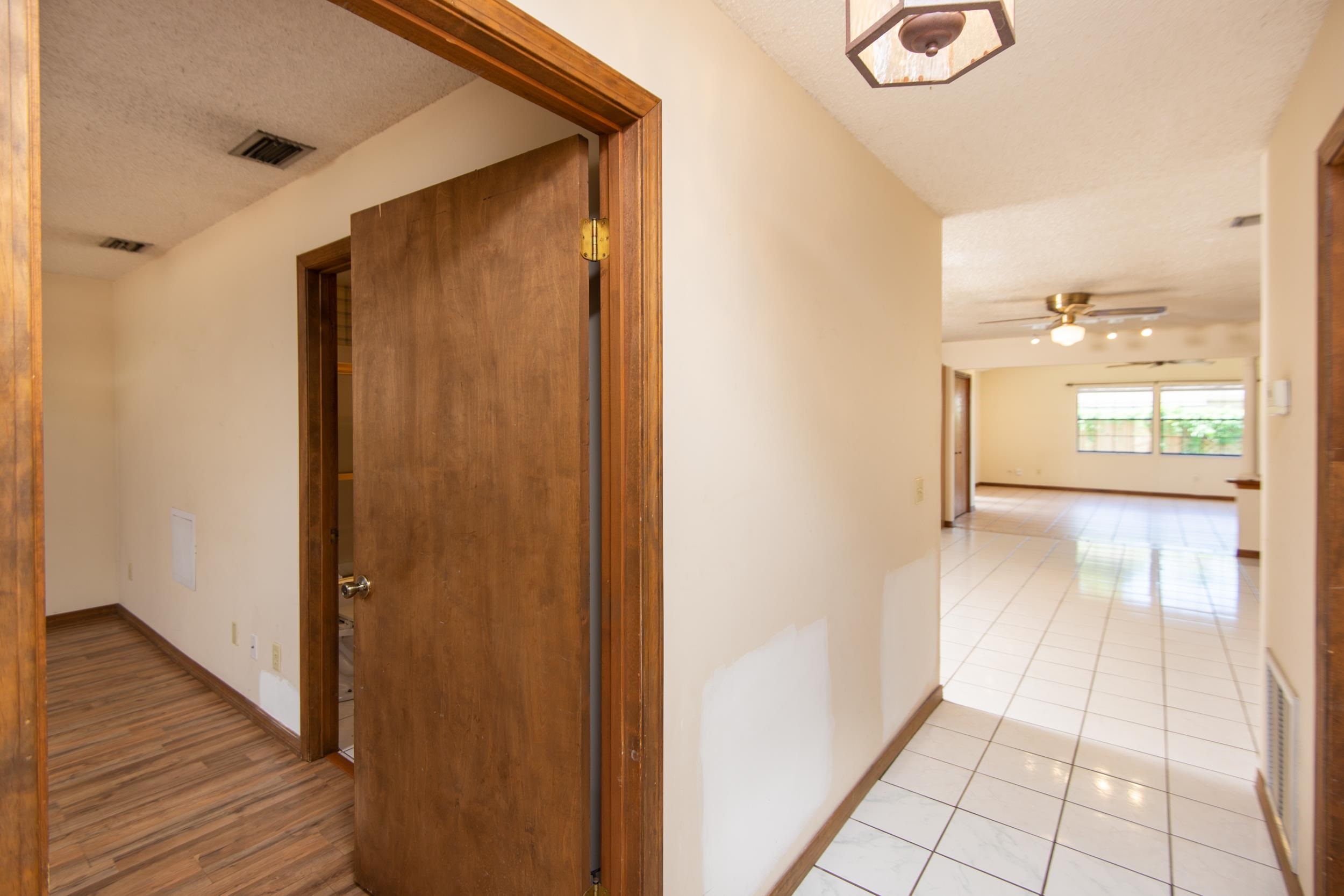 328 Linden Road St. Augustine, FL 32086 - Photo 6 of 62 a view of a hallway with wooden floor and a bathroom
