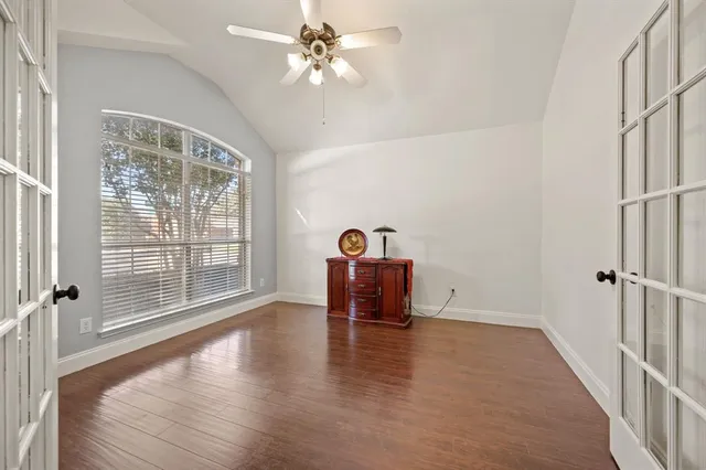 a view of room with window and wooden floor
