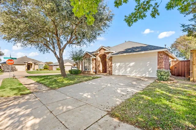 a front view of a house with a yard and a garage