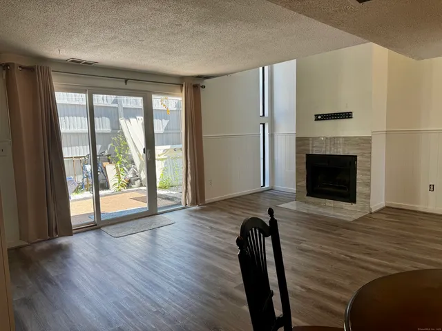 a view of a livingroom with furniture window and wooden floor