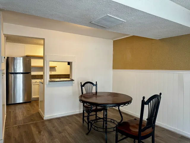 a view of a dining room with furniture and a window