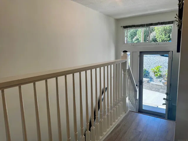a view of hallway with wooden floor