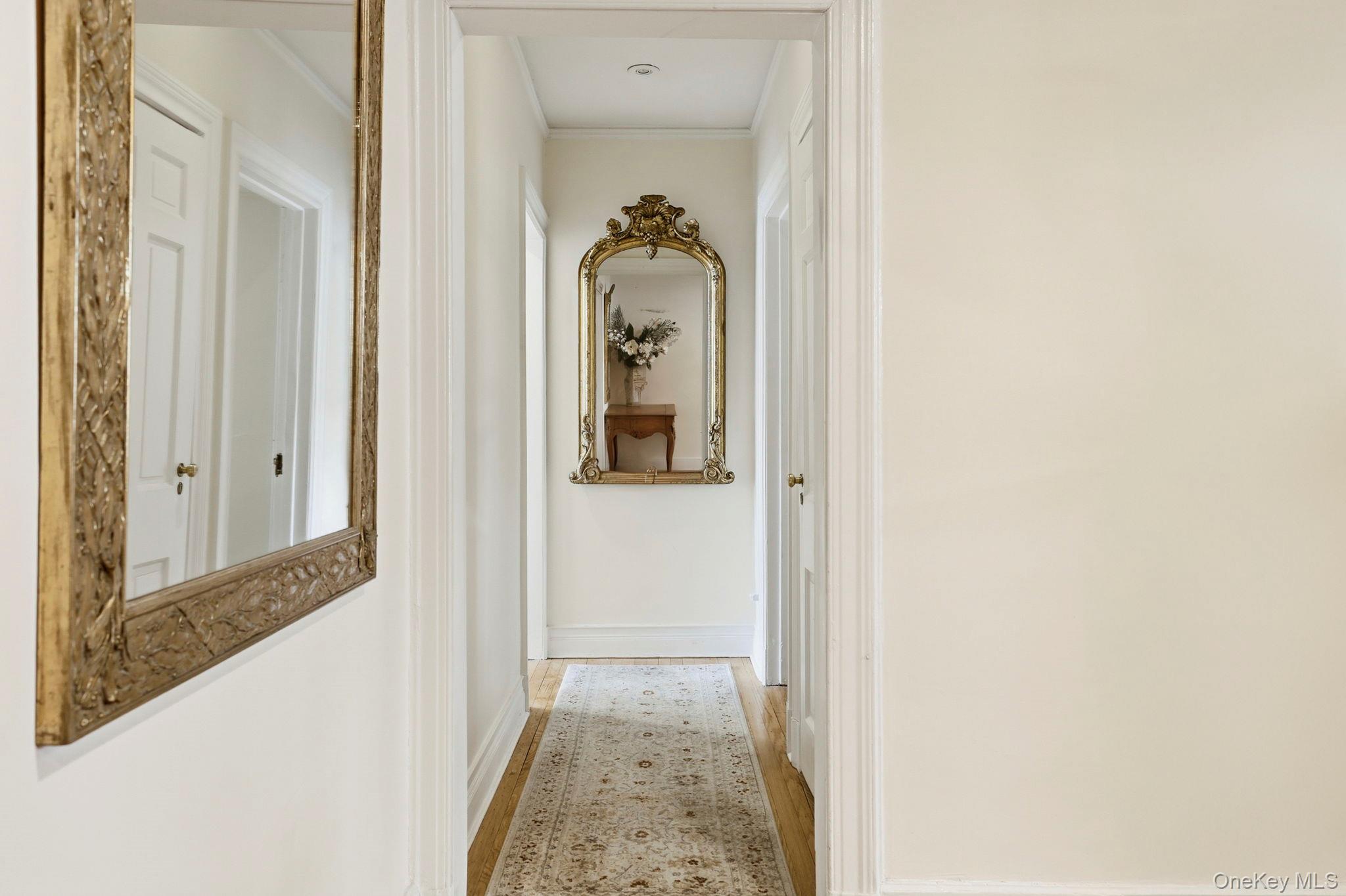 10 Brooklands, Unit 1H Bronxville, NY 10708 - Photo 19 of 33 a view of a hallway with wooden floor and a living room