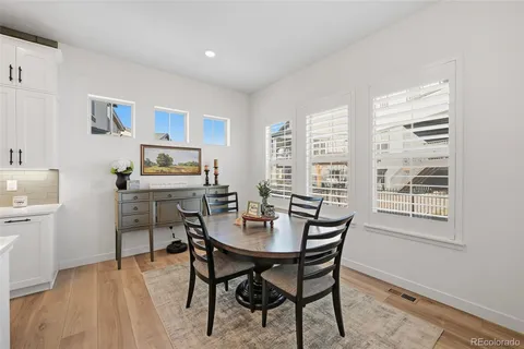 a dining room with a wooden table and chairs