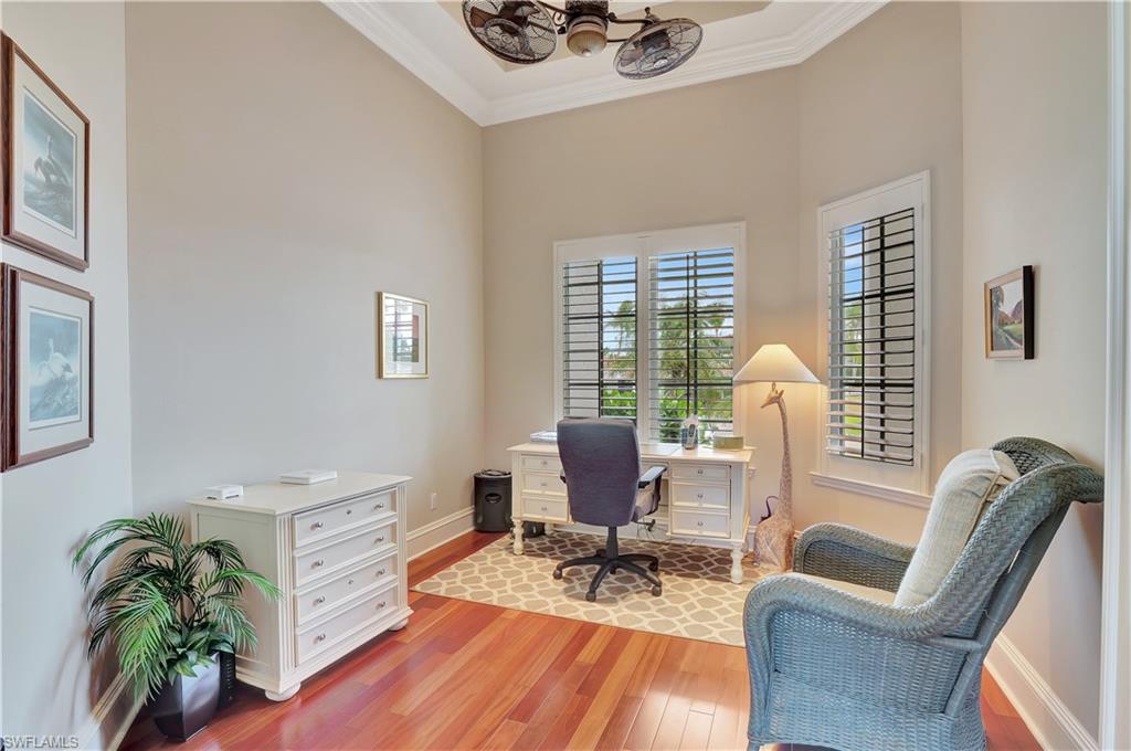 1380 Marlin Drive Naples, FL 34102 - Photo 14 of 48 Office featuring light wood-type flooring, crown molding, baseboards, a high ceiling, and a chandelier
