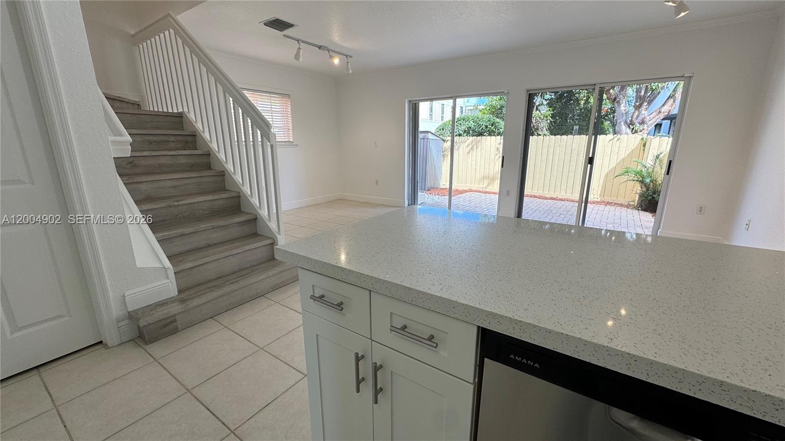 9465 Southwest 77th Court Miami, FL 33156 - Photo 12 of 25 a view of a kitchen with wooden floor and a window