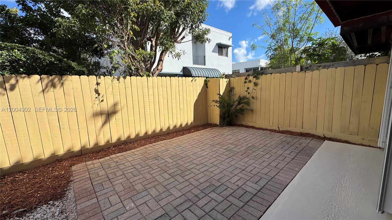 9465 Southwest 77th Court Miami, FL 33156 - Photo 25 of 25 a view of a pathway of a house with wooden fence