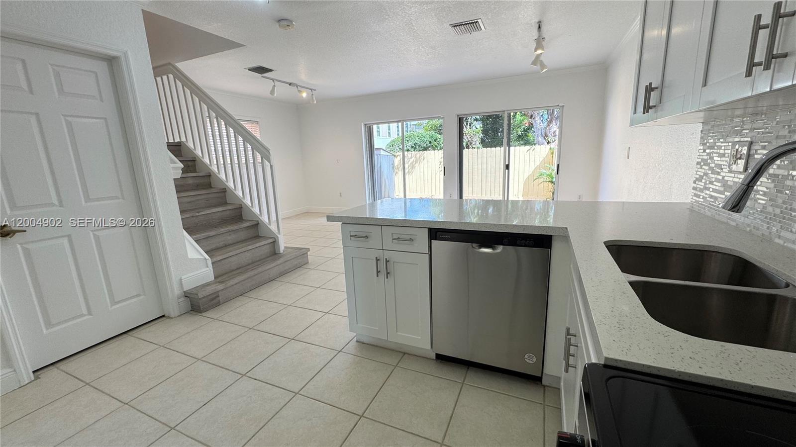 9465 Southwest 77th Court Miami, FL 33156 - Photo 4 of 25 a kitchen with a sink and a stove top oven