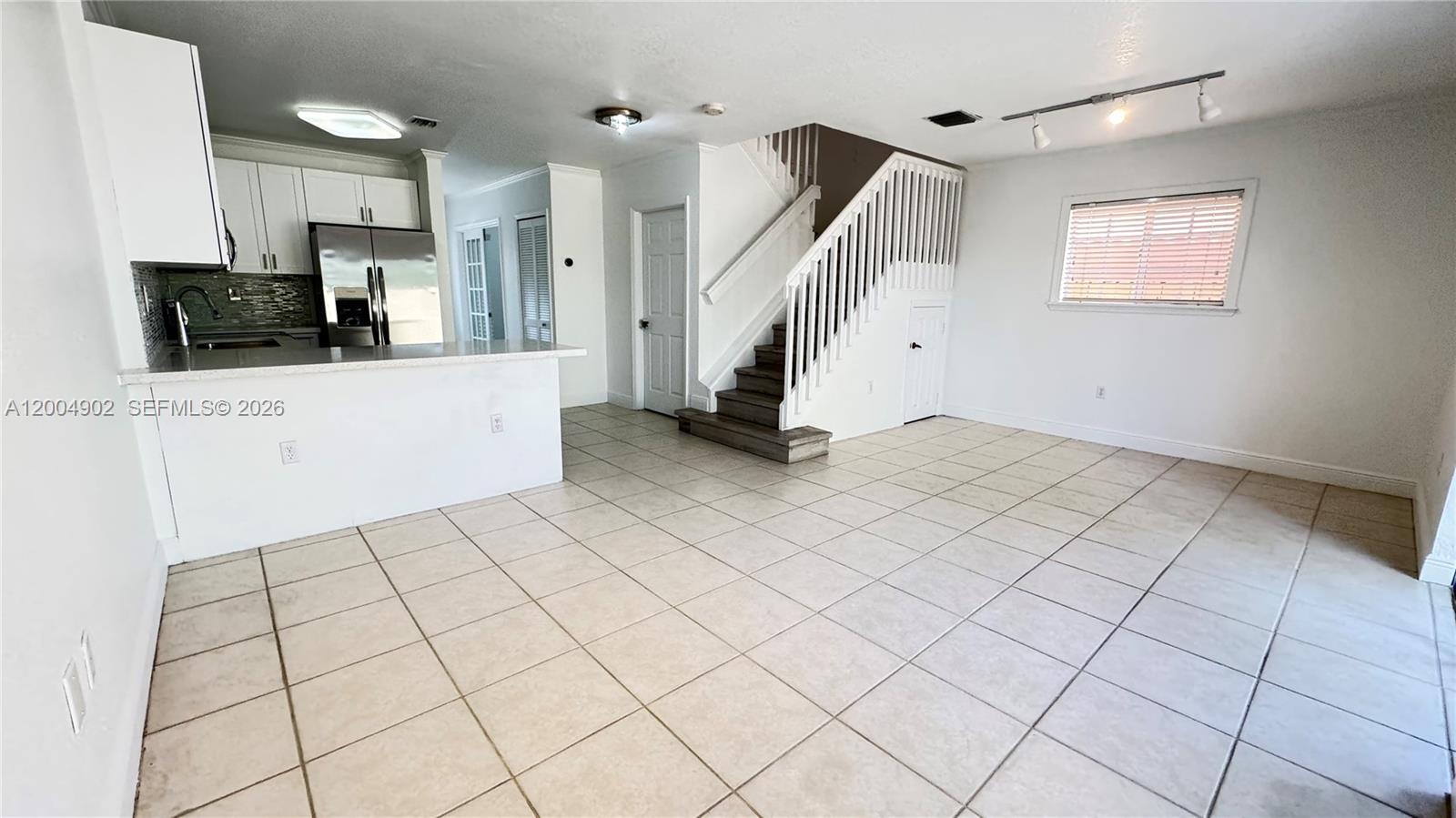 9465 Southwest 77th Court Miami, FL 33156 - Photo 7 of 25 a view of an empty room with a window