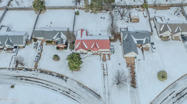 an aerial view of residential house with parking