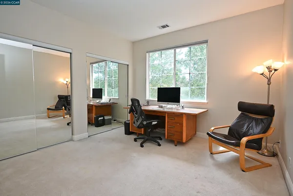 a spacious bedroom with a balcony a bed and a fireplace