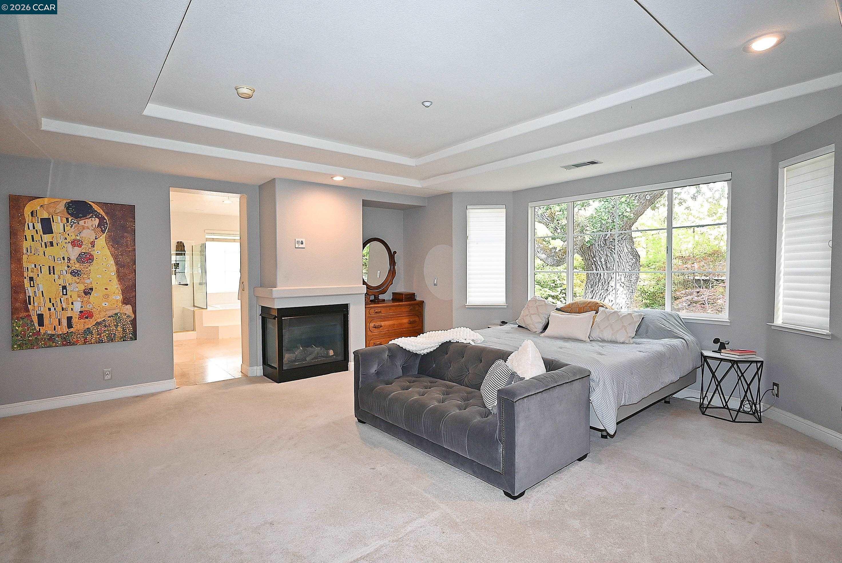 1239 Sunrise Ridge Drive Lafayette, CA 94549 - Photo 26 of 59 a spacious bedroom with a balcony a bed and a fireplace