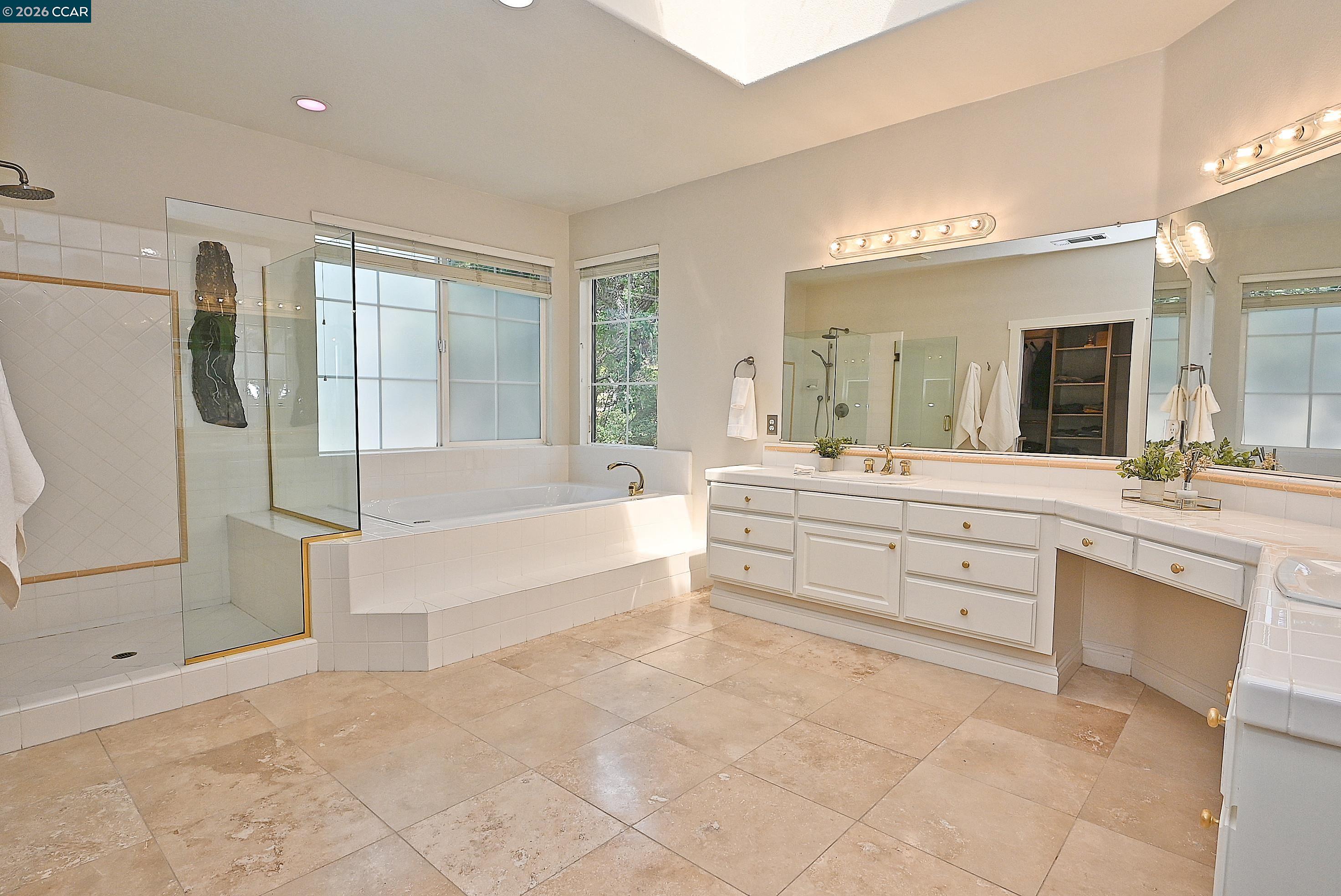 1239 Sunrise Ridge Drive Lafayette, CA 94549 - Photo 27 of 59 a spacious bathroom with a granite countertop sink mirror and bathtub