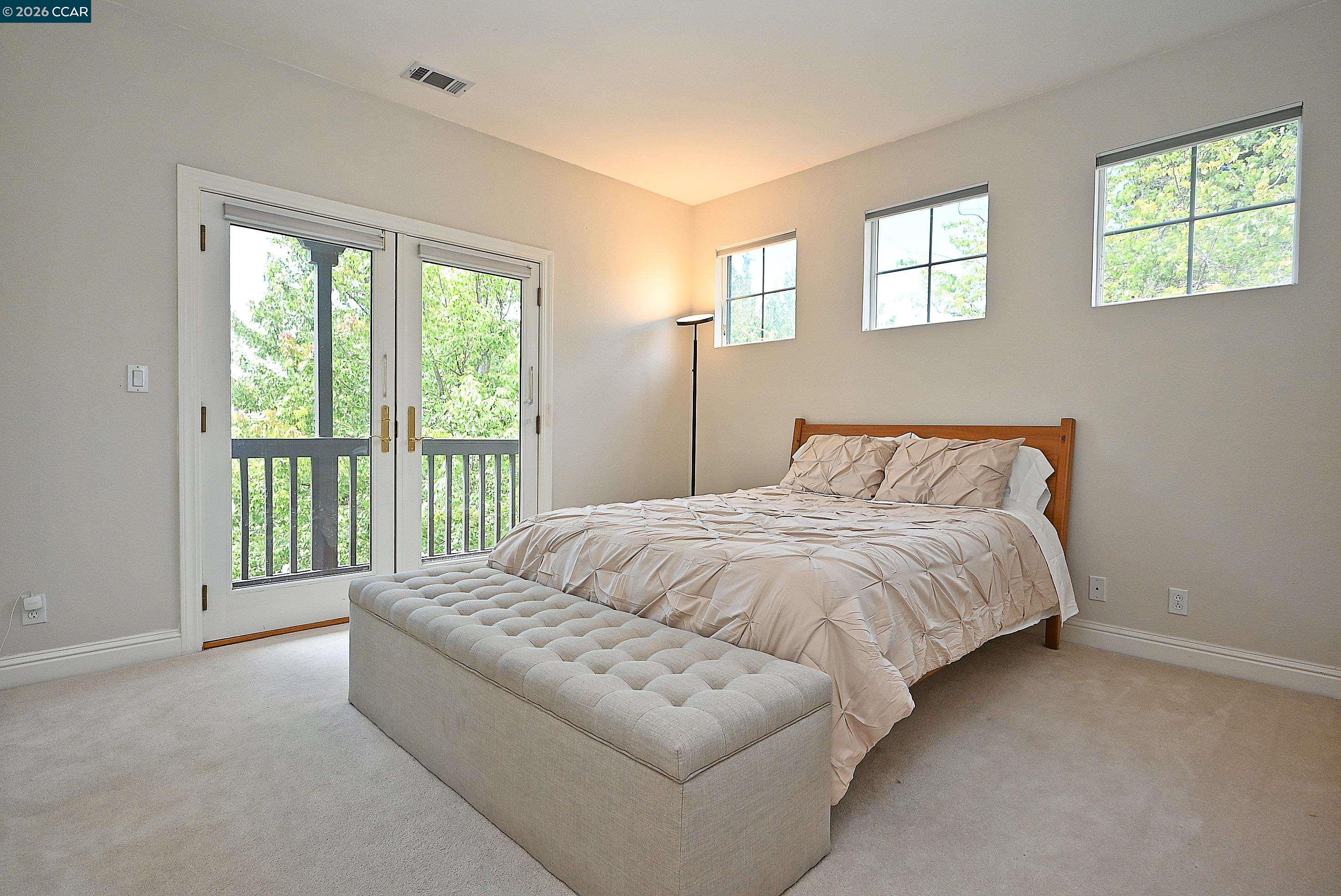1239 Sunrise Ridge Drive Lafayette, CA 94549 - Photo 33 of 59 a spacious bedroom with a bed and glass window