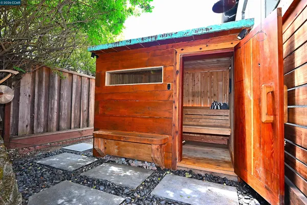 a view of a house with backyard and sitting area