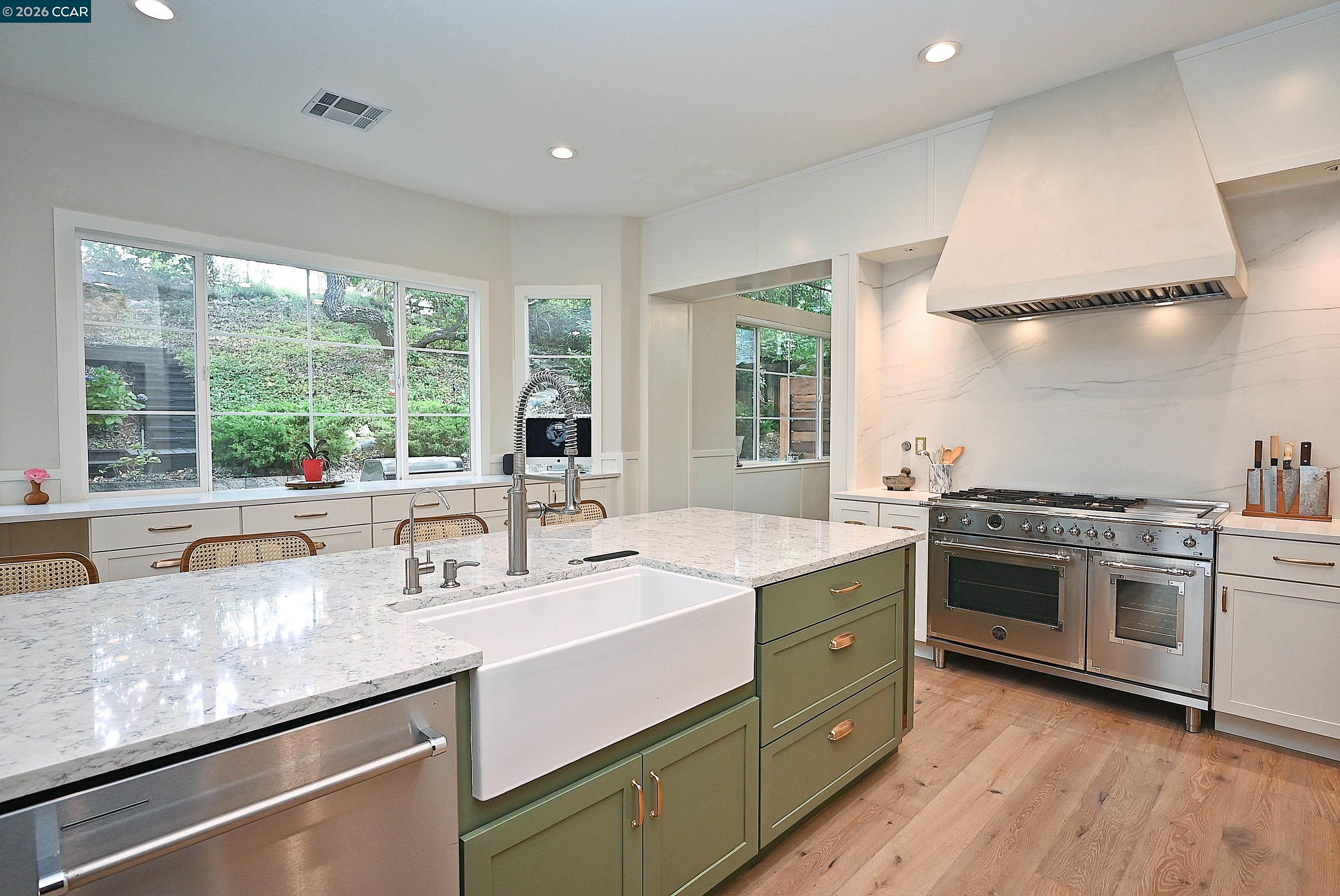 1239 Sunrise Ridge Drive Lafayette, CA 94549 - Photo 6 of 59 a kitchen with a sink stove and wooden cabinets