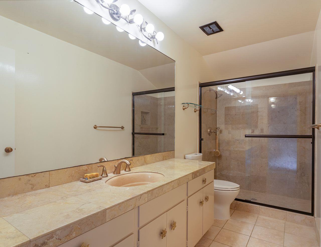 4 Country Club Gate, Unit 2 Pacific Grove, CA 93950 - Photo 11 of 11 a bathroom with a granite countertop sink toilet and shower
