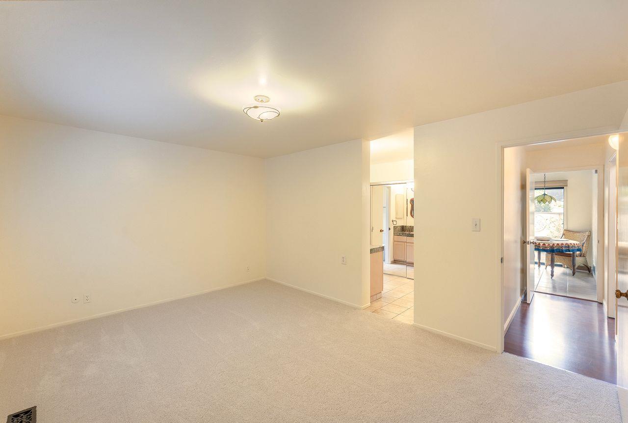 4 Country Club Gate, Unit 2 Pacific Grove, CA 93950 - Photo 7 of 11 an empty room with wooden floor and windows