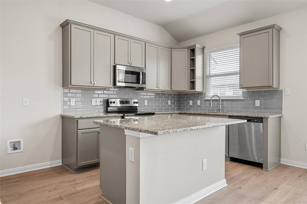 3224 Dottavio Road Lorena, TX 76655 - Photo 12 of 31 a kitchen with stainless steel appliances granite countertop a sink a stove a microwave and cabinets