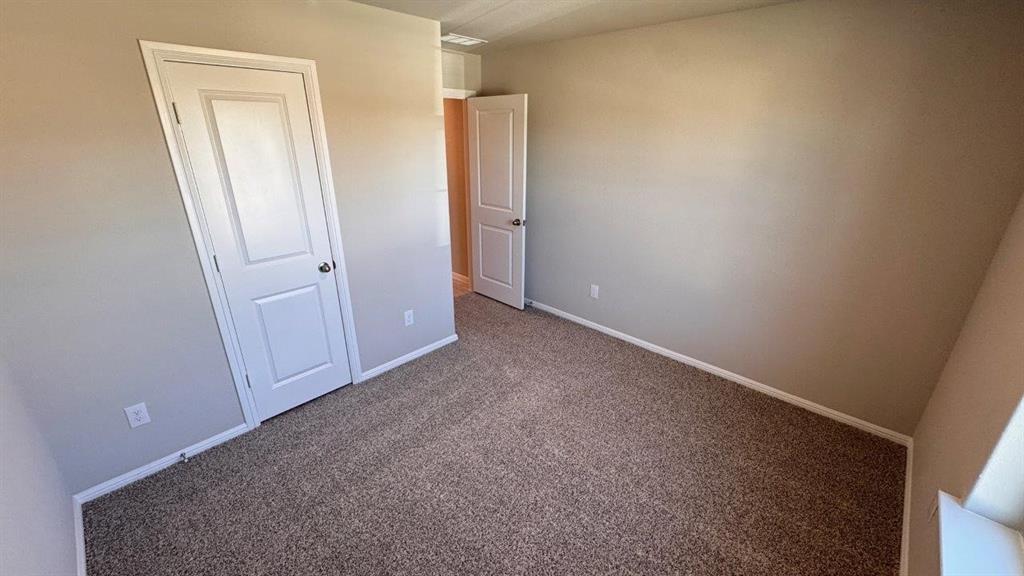 549 Marsh Street Cleburne, TX 76033 - Photo 12 of 20 an empty room with closet and mirror