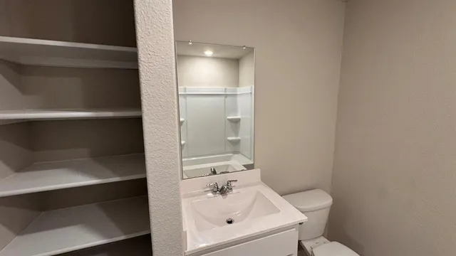 a bathroom with a toilet and a sink