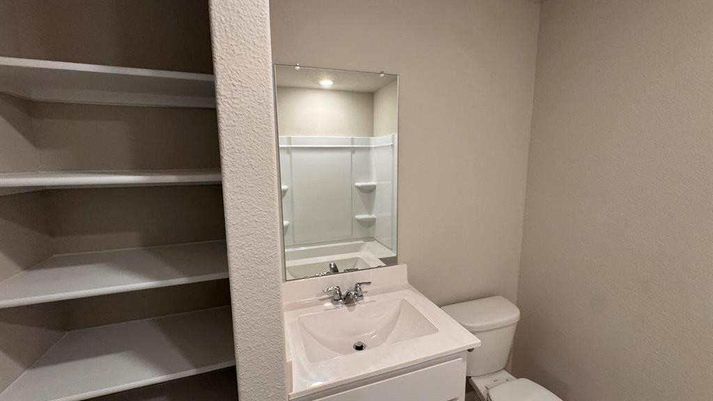 549 Marsh Street Cleburne, TX 76033 - Photo 15 of 20 a bathroom with a sink a toilet and shower