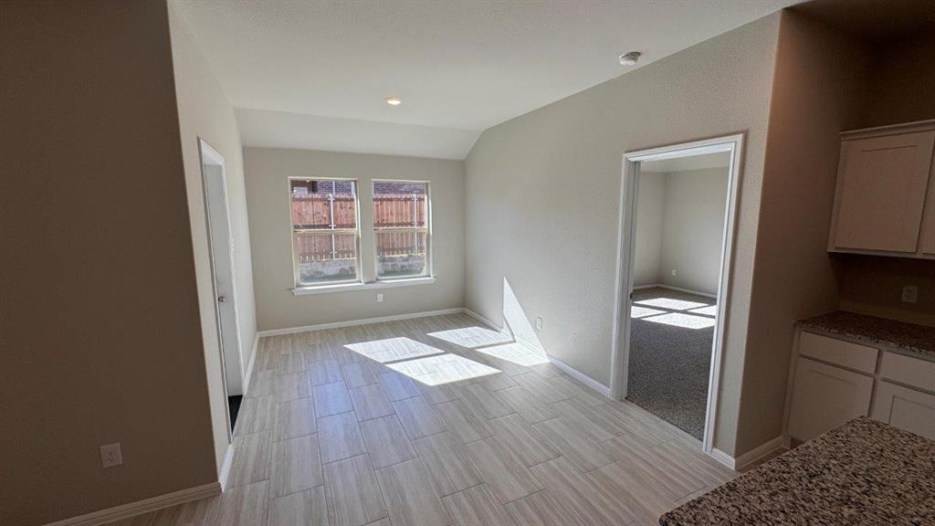 549 Marsh Street Cleburne, TX 76033 - Photo 4 of 20 a view of empty room with wooden floor and fan
