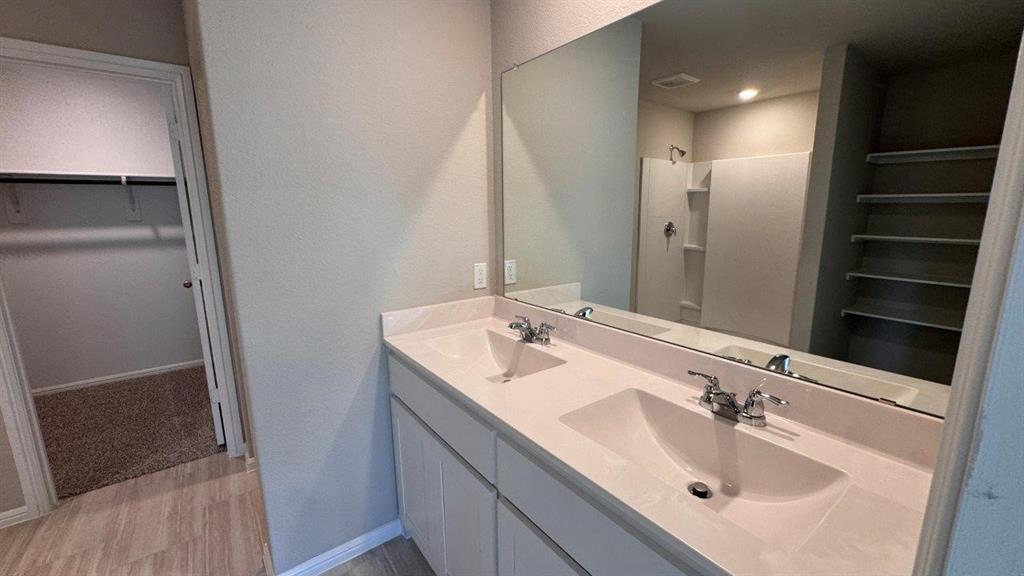 549 Marsh Street Cleburne, TX 76033 - Photo 9 of 20 a bathroom with a sink and a mirror