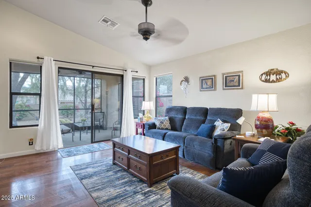 a kitchen with white cabinets and sink
