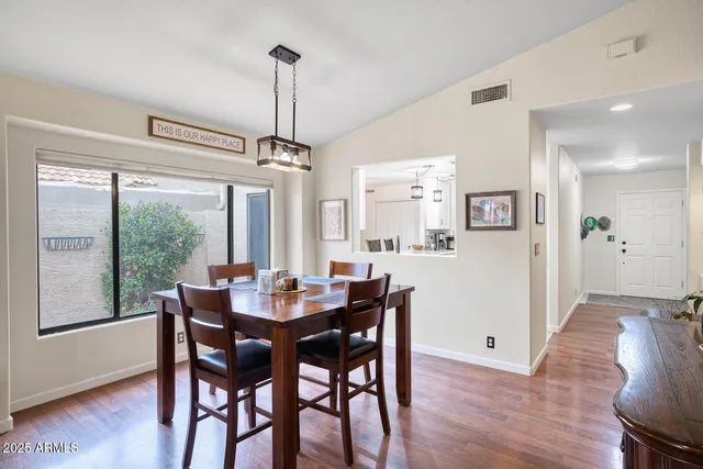 a kitchen with white cabinets and sink